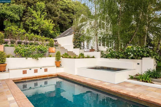 a view of a house with backyard sitting area and garden
