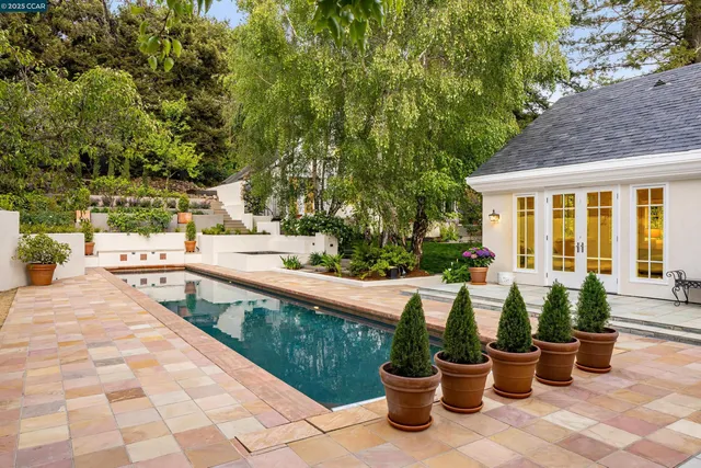 a view of a patio with chairs and plants