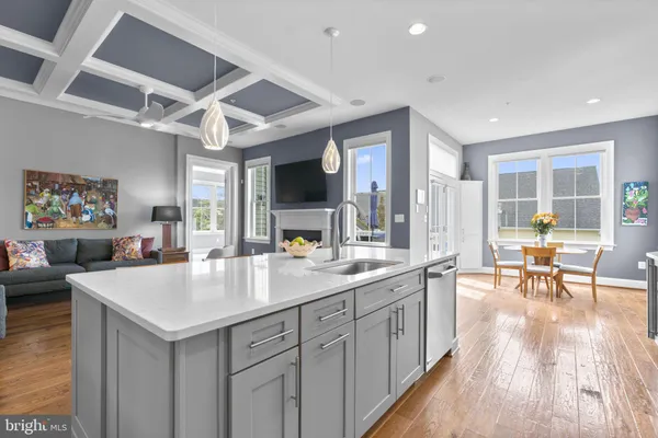 a bedroom with a large bed a flat tv screen and a chandelier