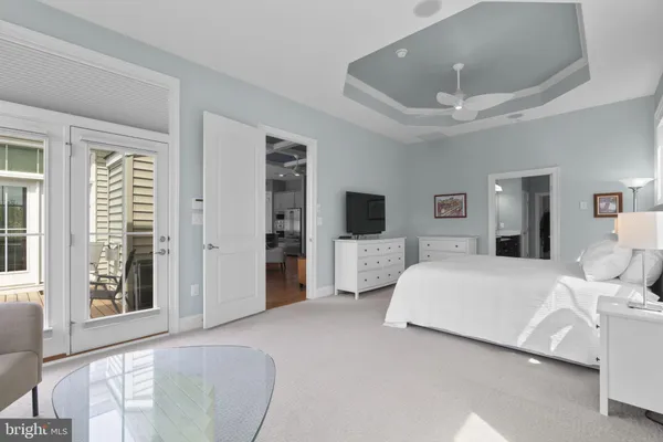 a bathroom with a shower sink vanity mirror and toilet