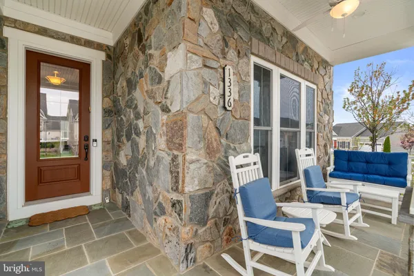 a living room with furniture kitchen view and a fireplace