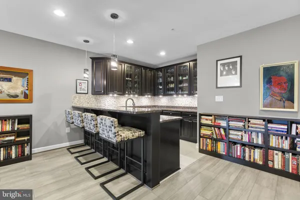 a view of a roof deck with table and chairs under an umbrella with wooden floor