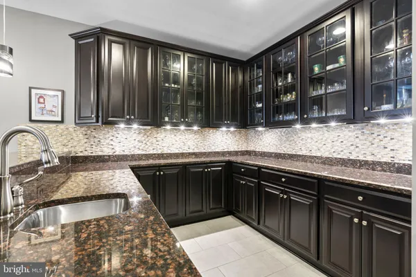 a view of a roof deck with table and chairs under an umbrella with wooden floor