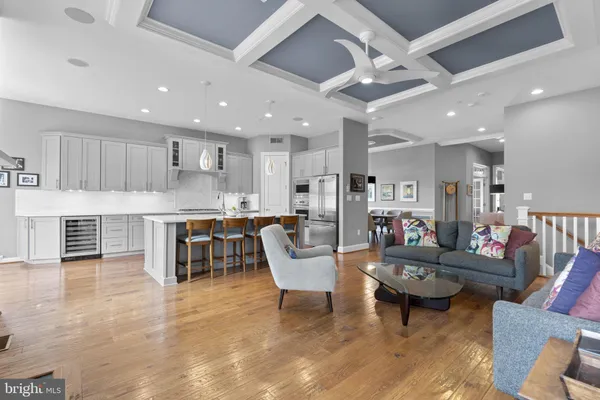 a dining room with furniture a chandelier and wooden floor
