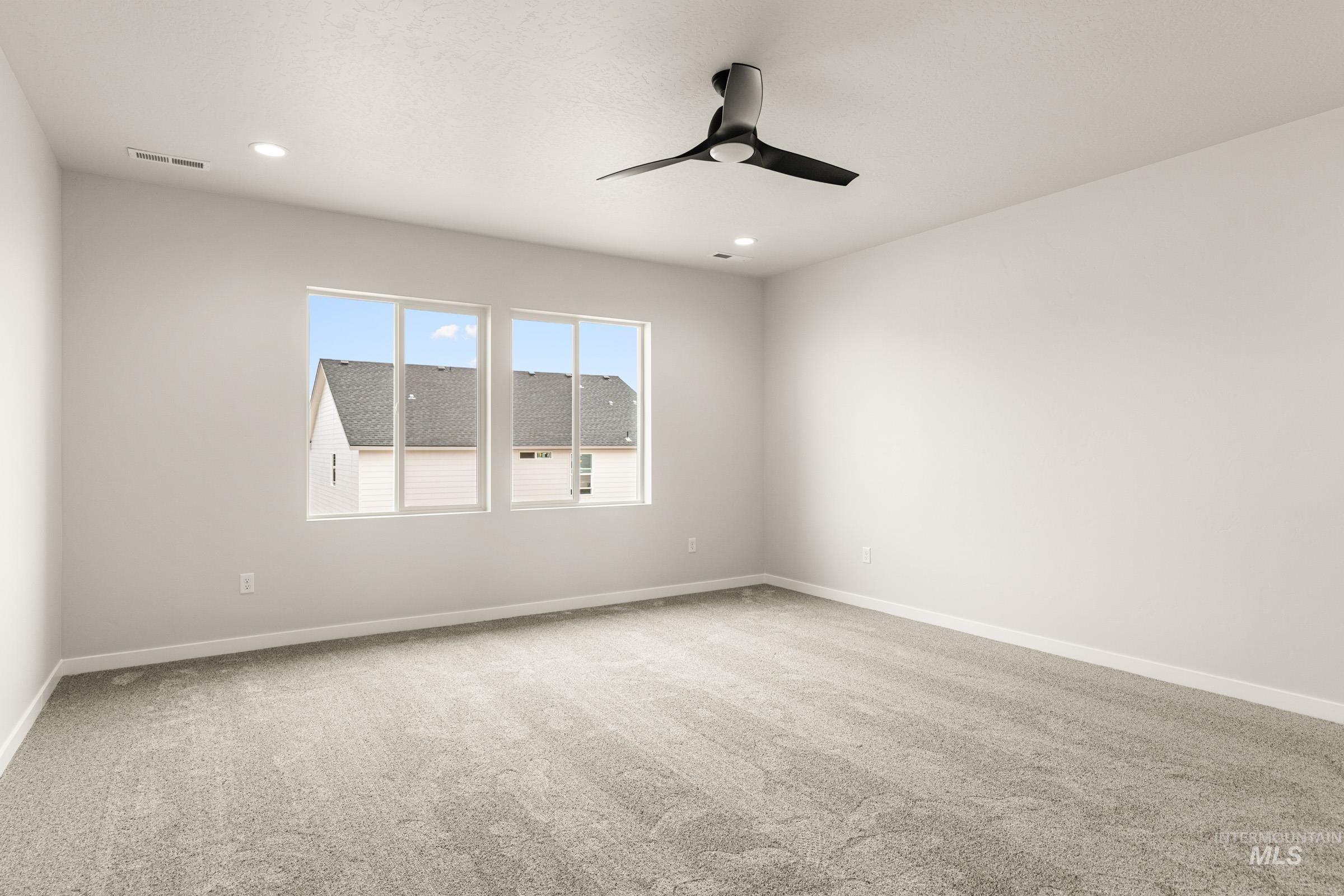 13688 Redway Court Caldwell, ID 83607 - Photo 13 of 26 Spare room featuring light colored carpet, a ceiling fan, and recessed lighting