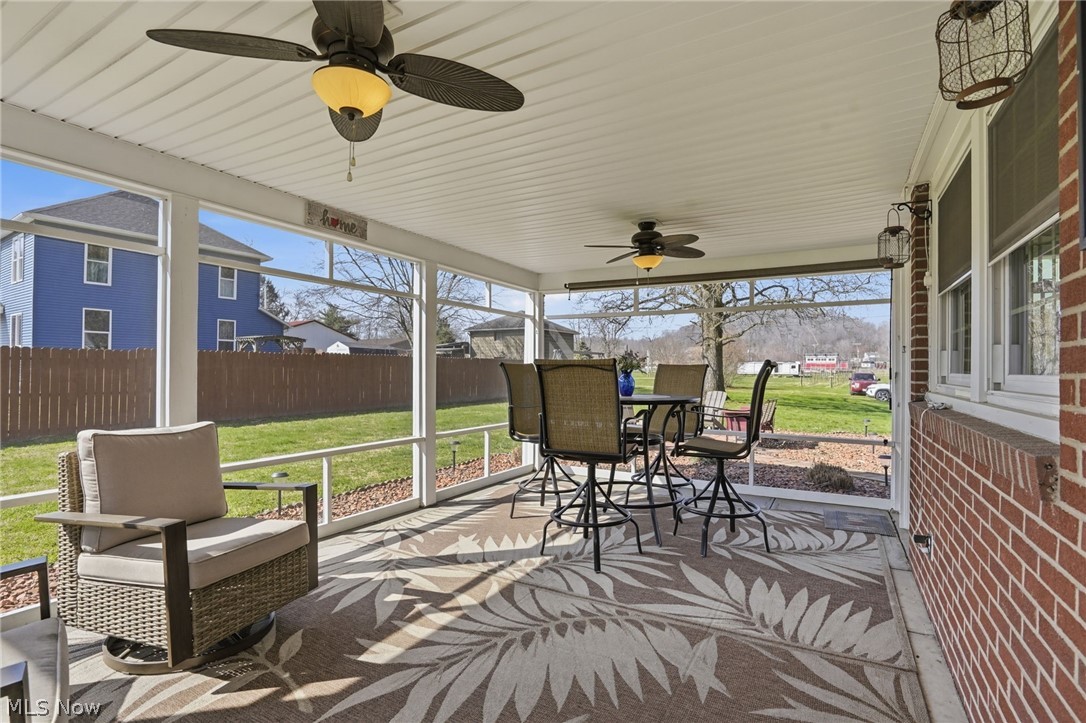 6655 Ceramic Road Crooksville, OH 43731 - Photo 29 of 34 Sunroom with a ceiling fan and outdoor dining space