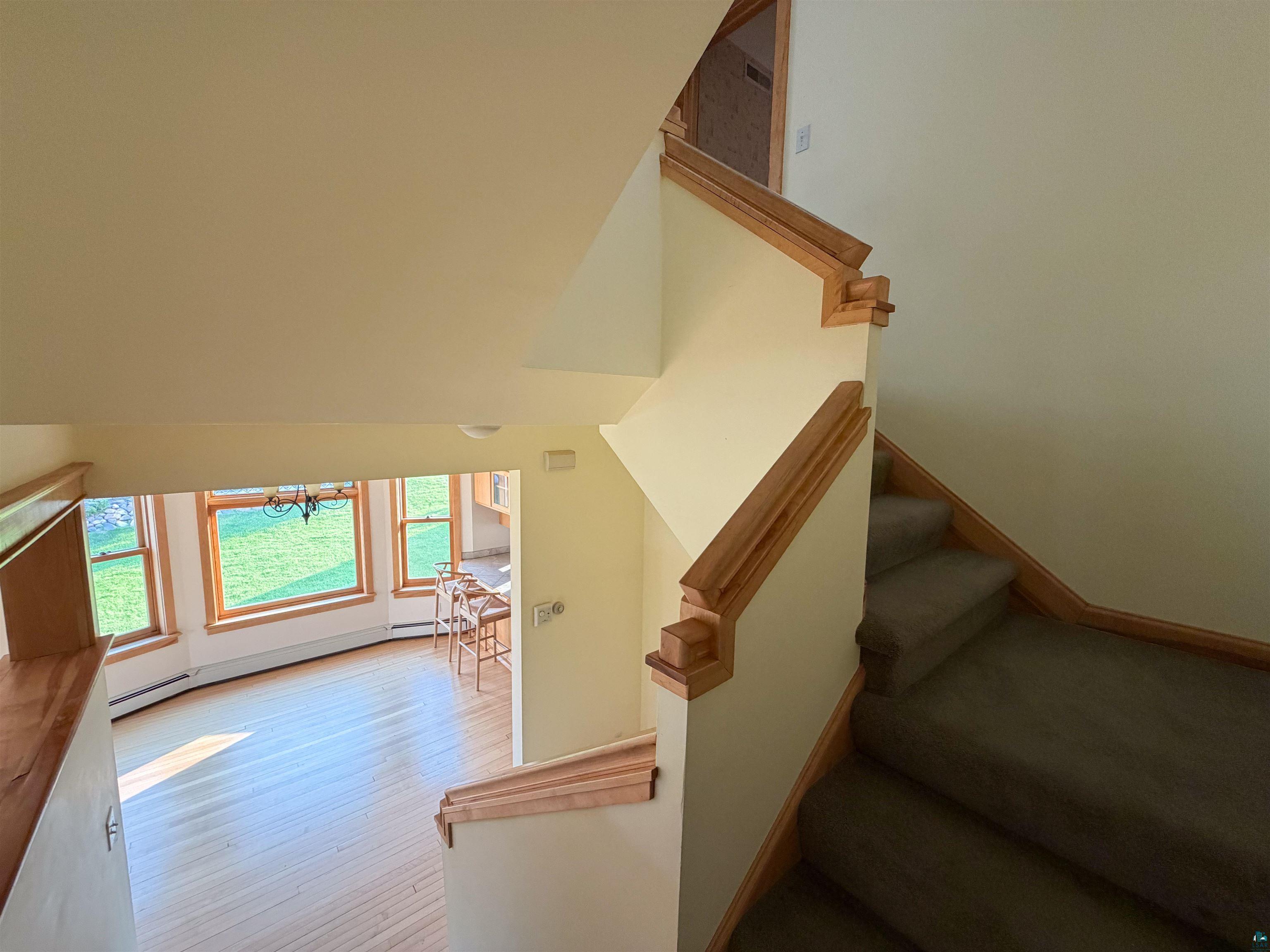 13 West 8th Street Duluth, MN 55806 - Photo 17 of 57 Carpeted staircase with wood-finish handrails