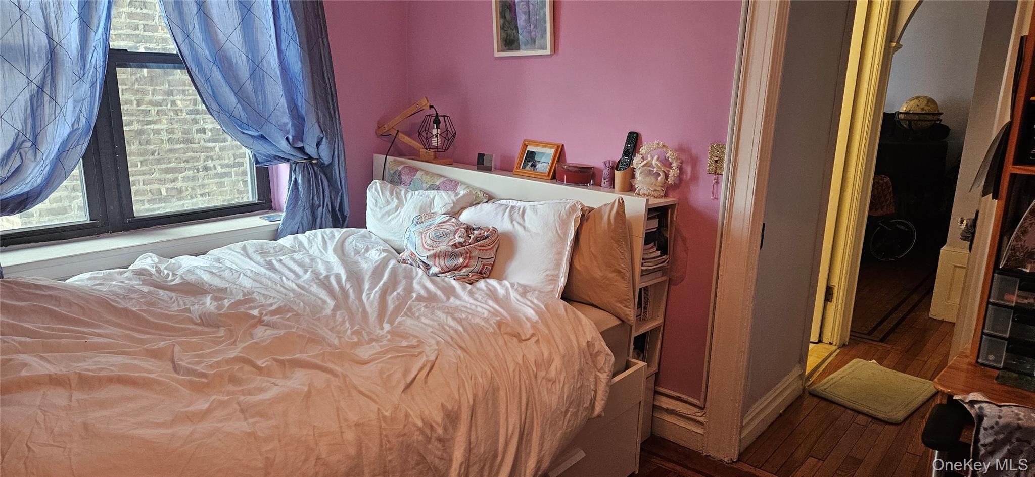 130 Bay Ridge Parkway, Unit 4E Brooklyn, NY 11209 - Photo 10 of 12 a bed sitting in a bedroom next to a window