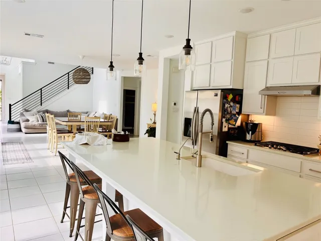 a kitchen with a sink a counter and appliances