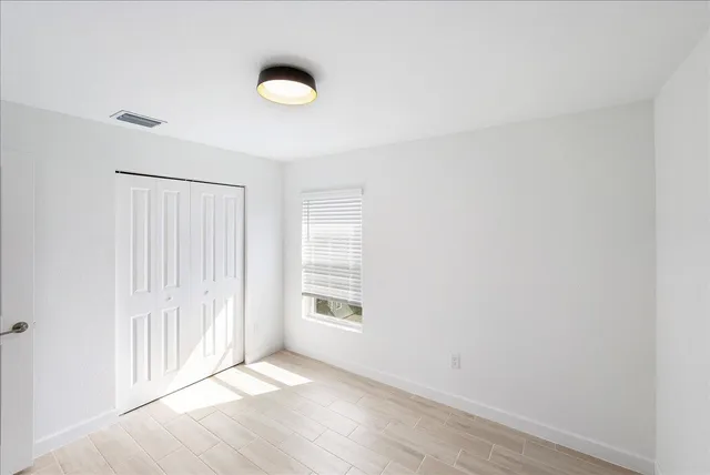 a view of an empty room with windows