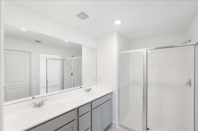 a bathroom with a double vanity sink and mirror