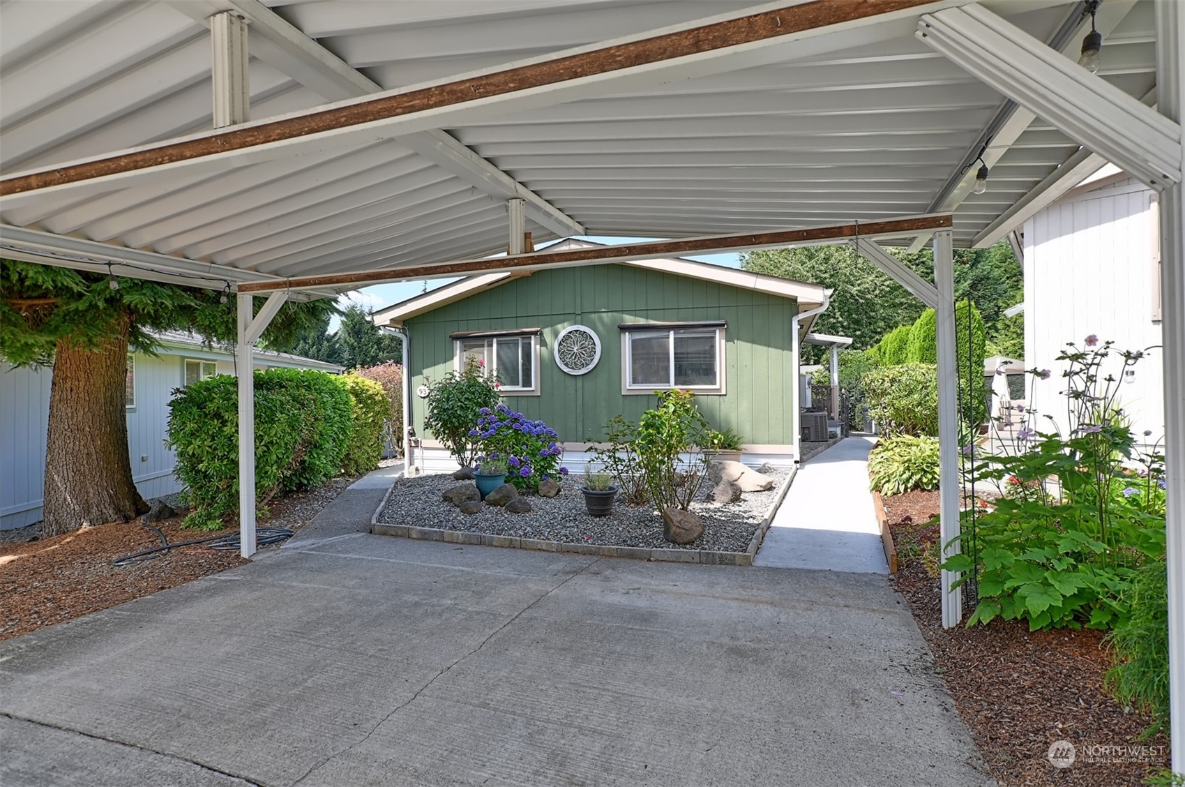 23825 15th Avenue Southeast, Unit 93 Bothell, WA 98021 - Photo 2 of 21 a view of a patio with table and chairs under an umbrella