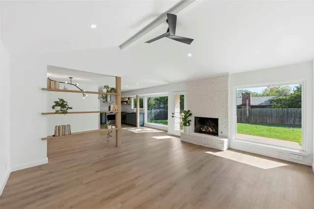 a living room with fireplace furniture and a floor to ceiling window