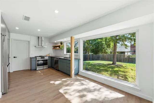 a kitchen with stainless steel appliances granite countertop a refrigerator and a sink