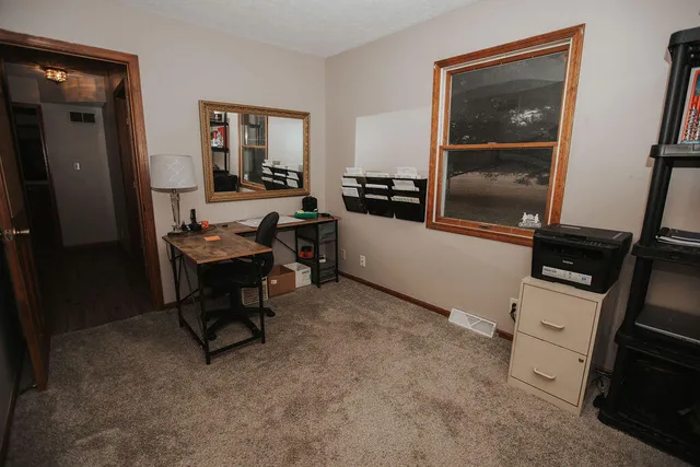 a workspace with furniture and window