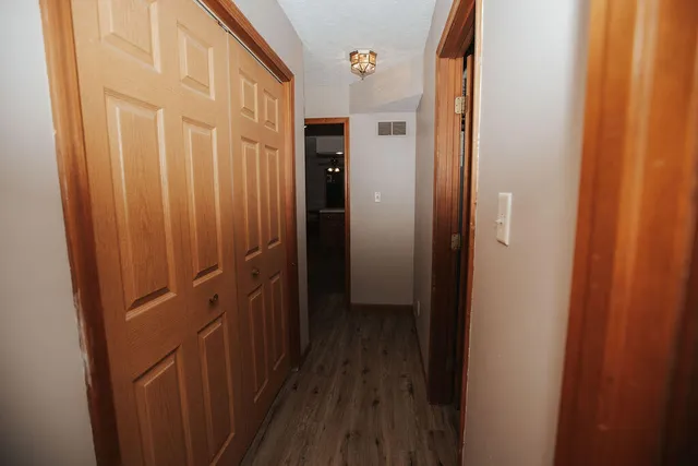 a view of a hallway with wooden floor