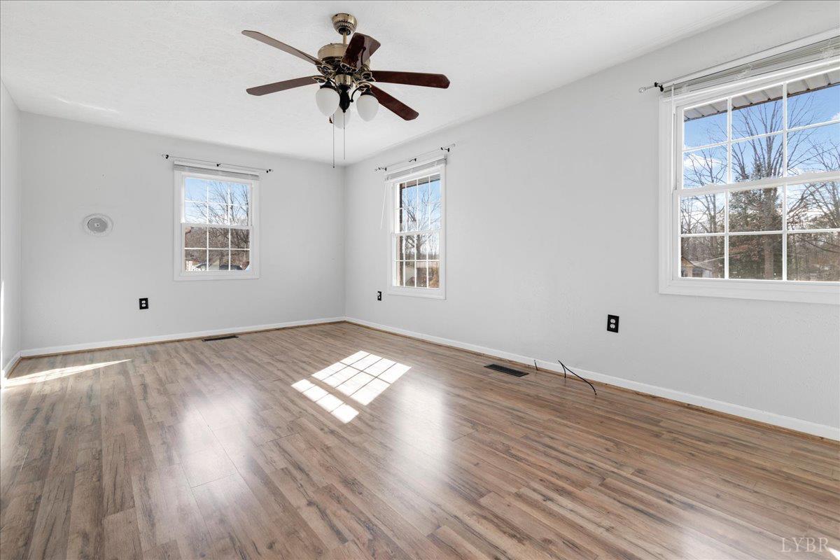 813 Doss Road Concord, VA 24538 - Photo 7 of 31 a view of empty room with wooden floor and fan