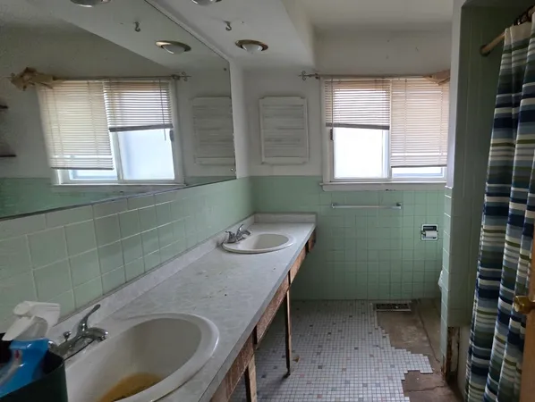 a bathroom with a sink and mirror