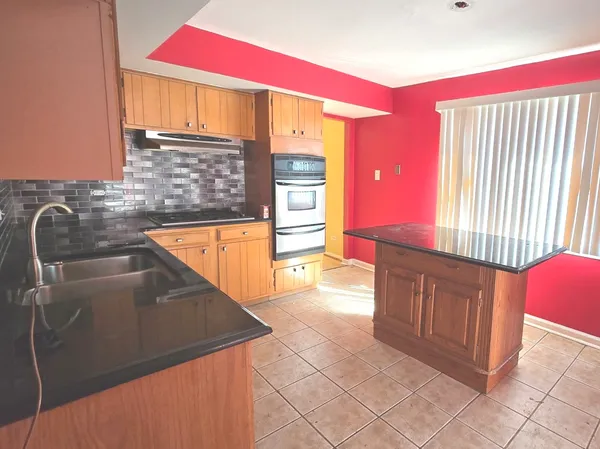 a kitchen with stainless steel appliances a sink and a microwave