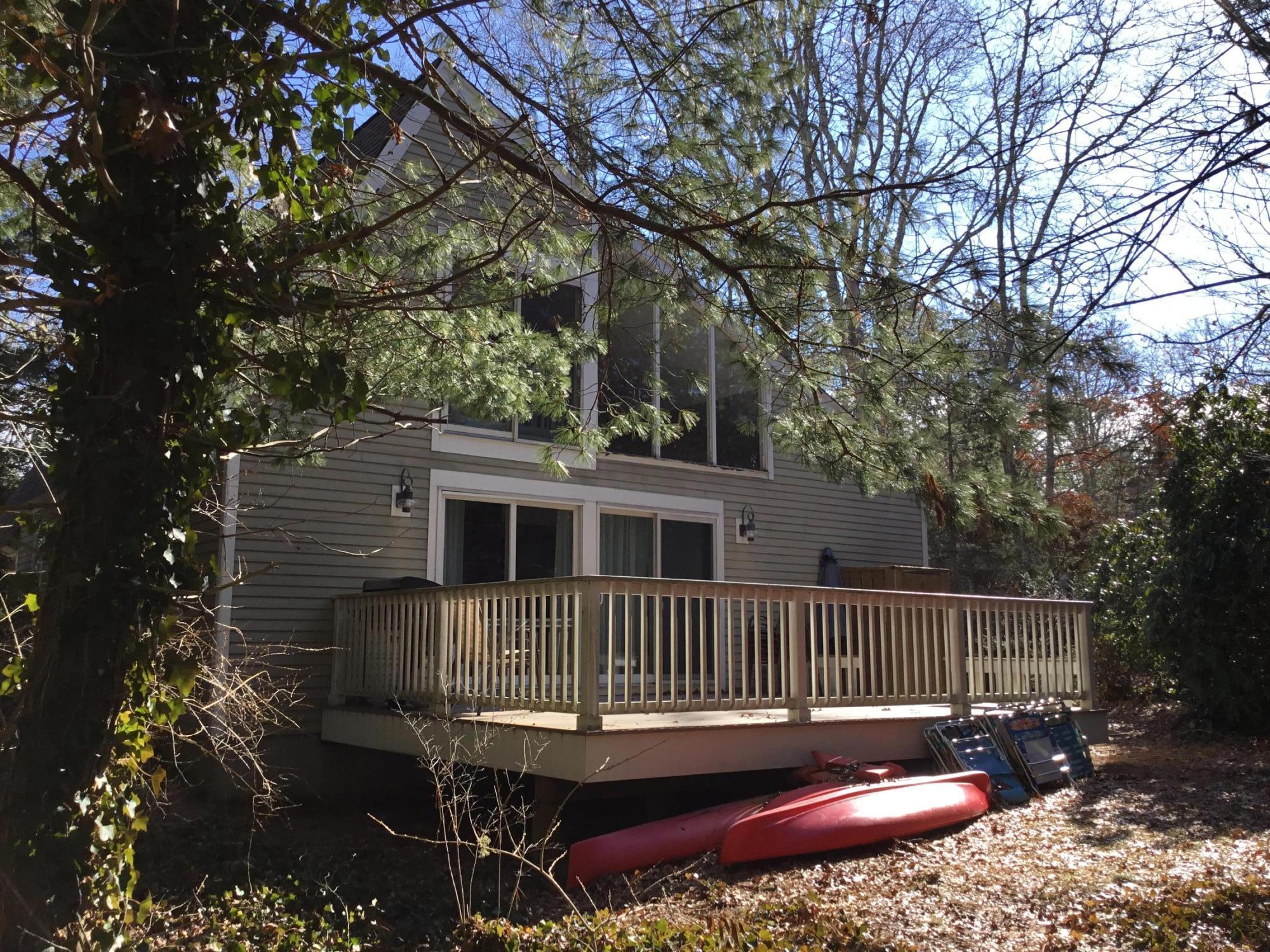 198 Fells Pond Road Mashpee, MA 02649 - Photo 1 of 33 a view of a house with a roof deck