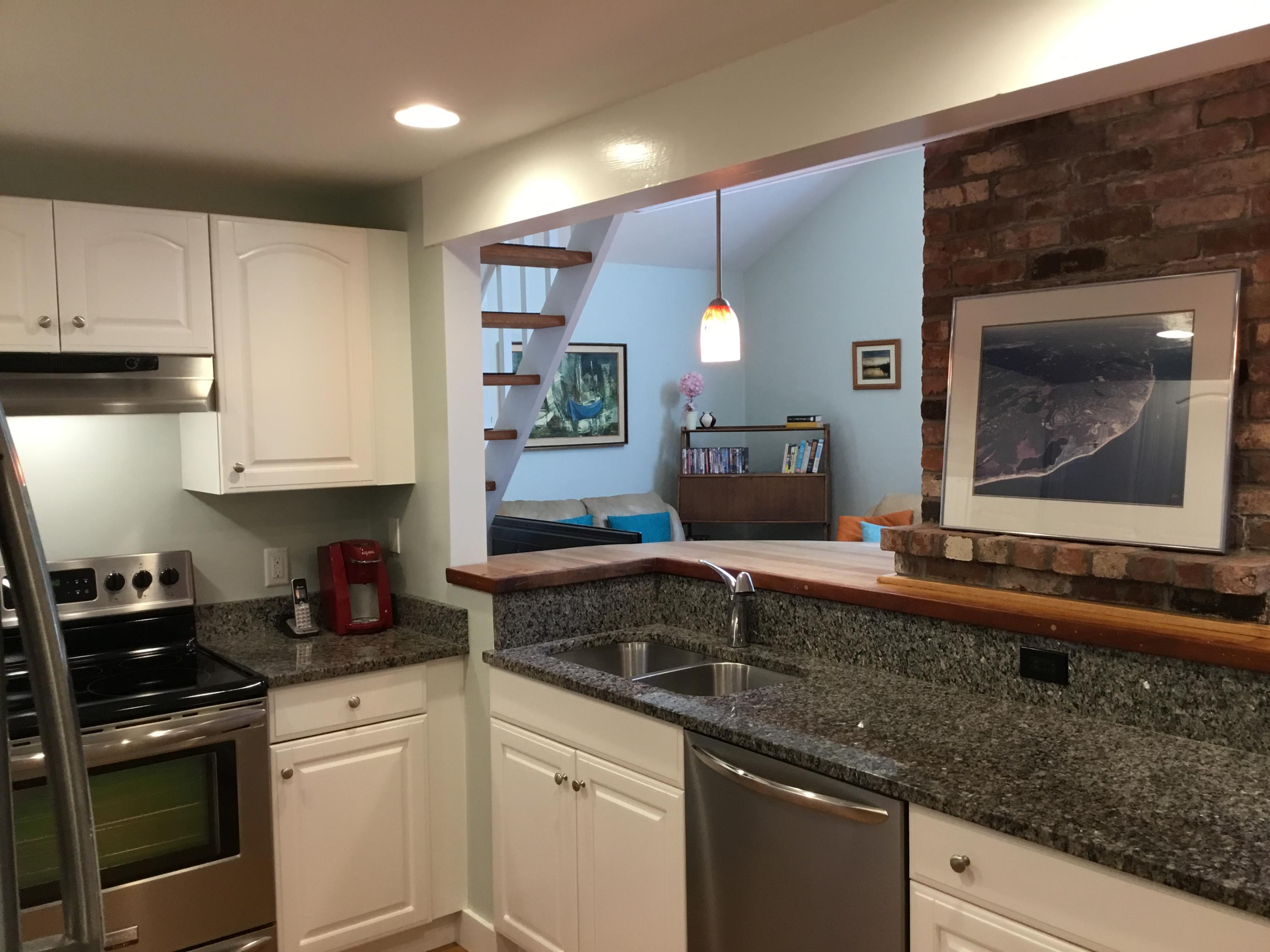 198 Fells Pond Road Mashpee, MA 02649 - Photo 7 of 33 a kitchen with stainless steel appliances granite countertop a sink stove and cabinets