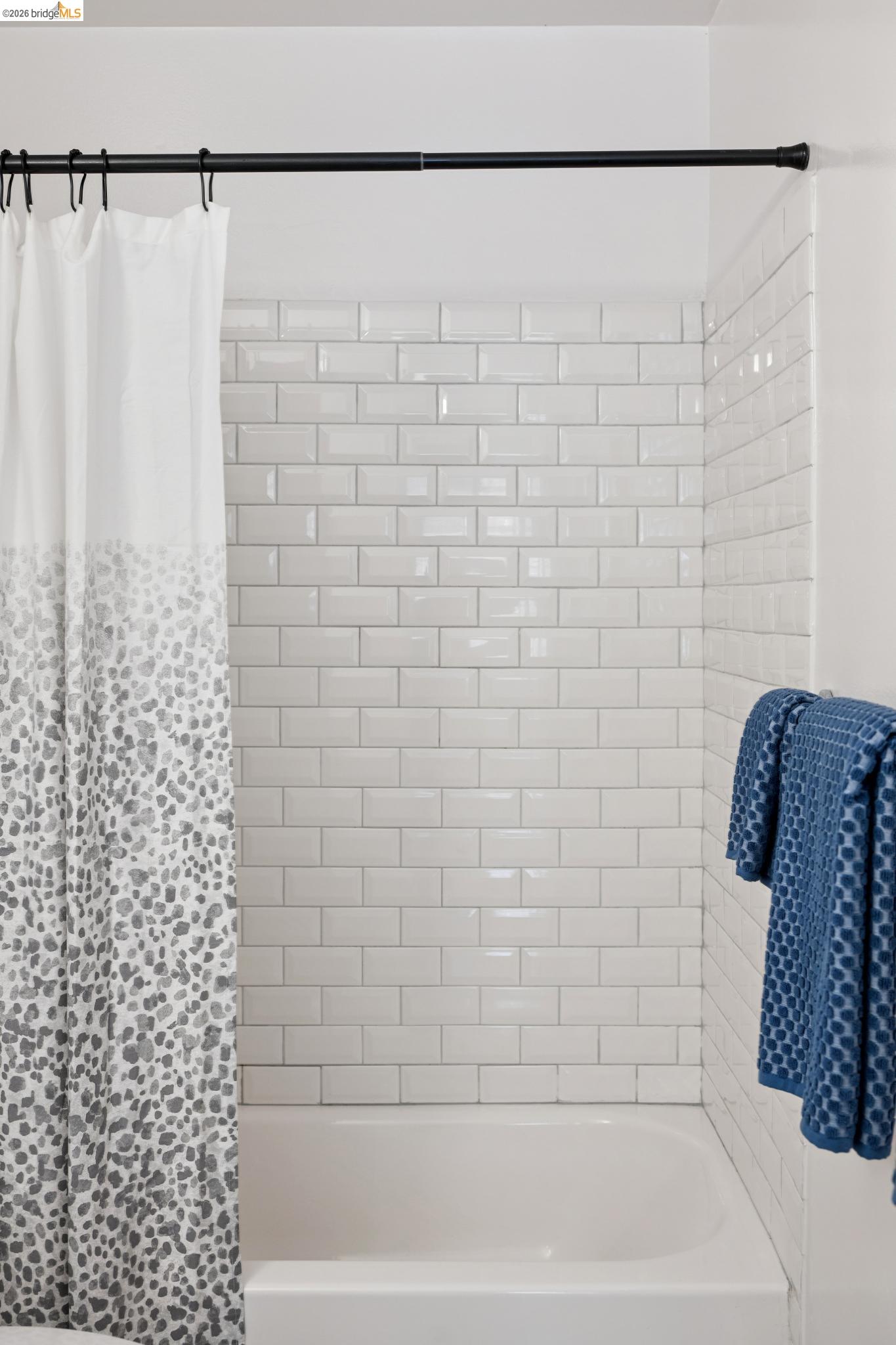 1340 Henry Street Berkeley, CA 94709 - Photo 43 of 52 Bathtub with white subway tile surround, white porcelain finish, and a black shower rod