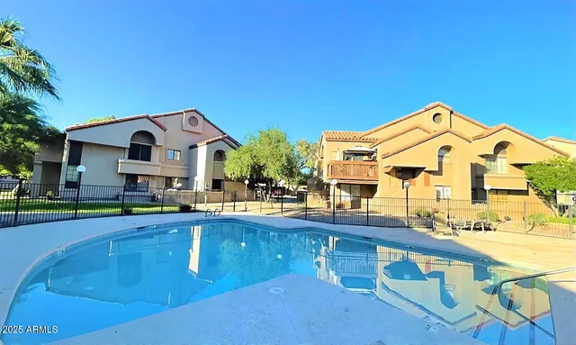 a front view of house with yard and swimming pool
