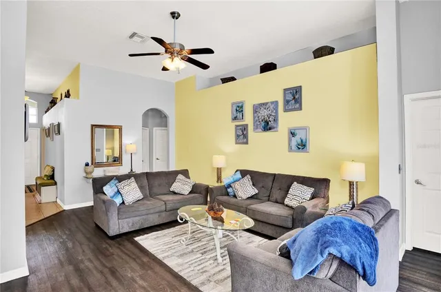 a living room with furniture and wooden floor