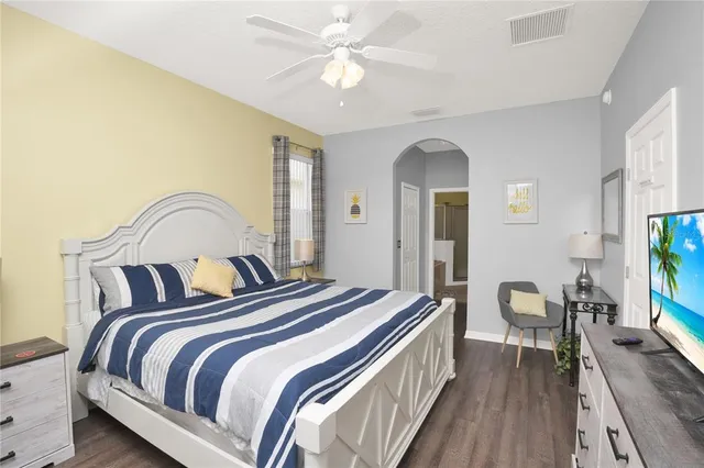 a bedroom with bed and a chandelier