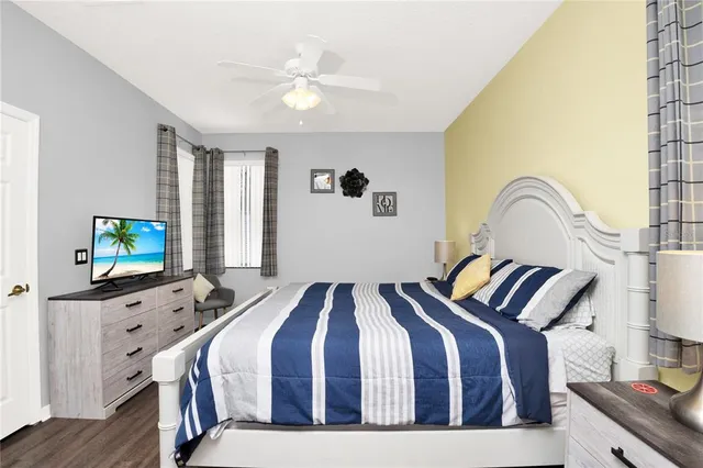 a bedroom with two beds and a flat screen tv