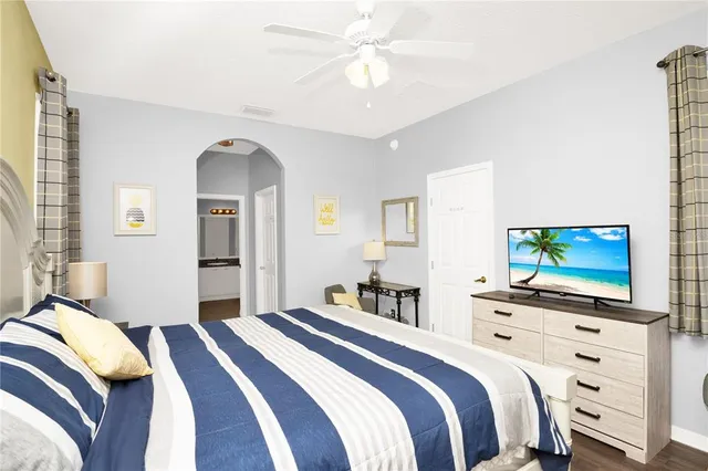 a bedroom with a bed and a flat screen tv