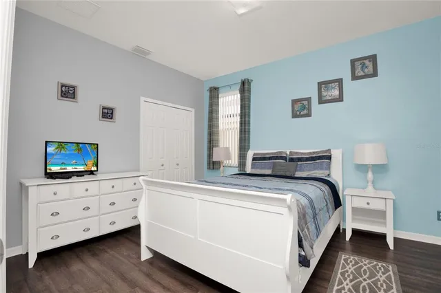 a bed room with a bed and a television