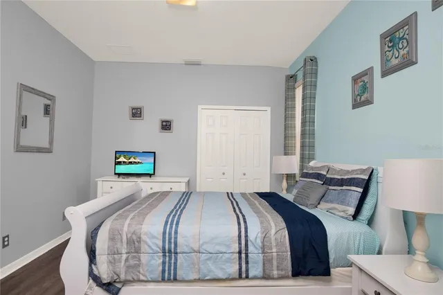 a bedroom with a bed and painting on the wall