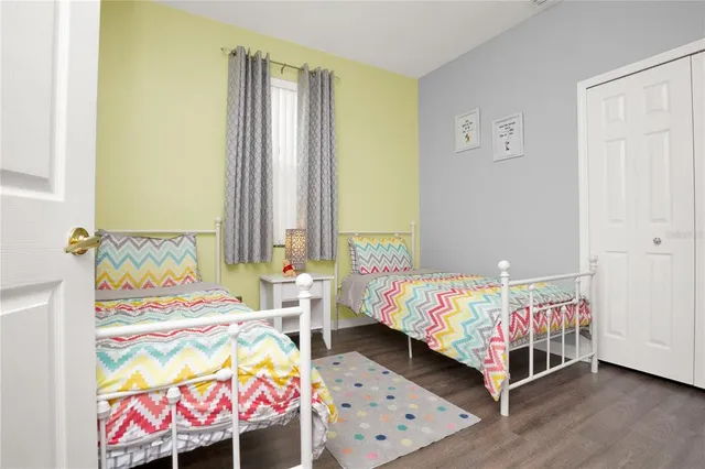 a bedroom with two beds and a dresser