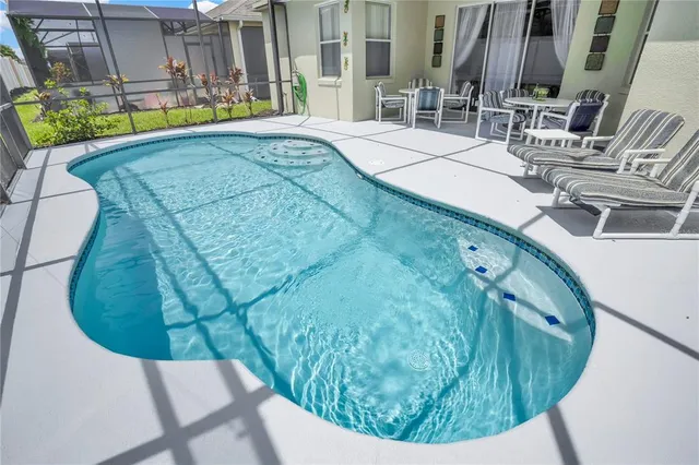 swimming pool view with a sitting space