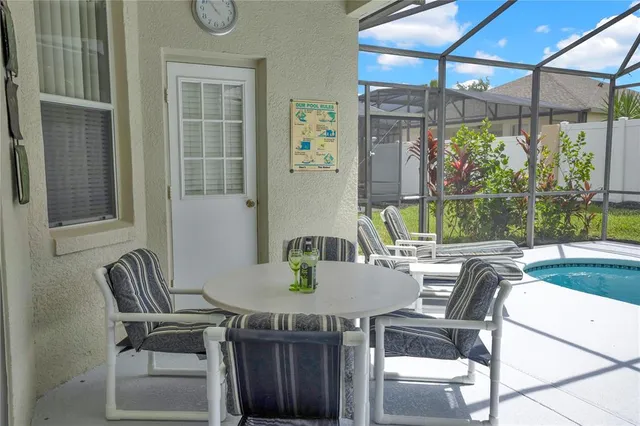 a view of an outdoor dining space with a table and chairs