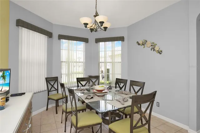 a view of a dining room with furniture and chandelier