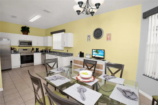 a view of a dining room with furniture and a window