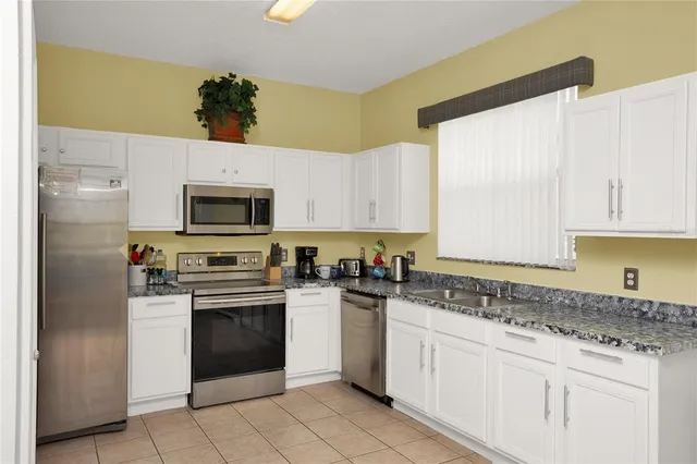 a kitchen with a stove a sink and a microwave