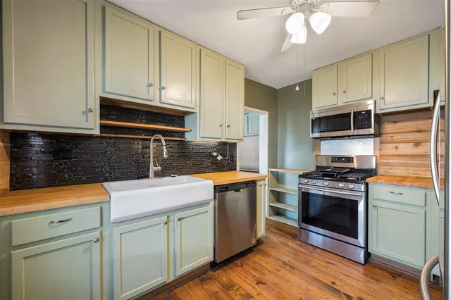 a kitchen with granite countertop stainless steel appliances and wooden cabinets