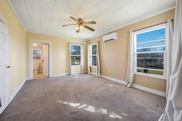 a view of a livingroom with a ceiling fan and window