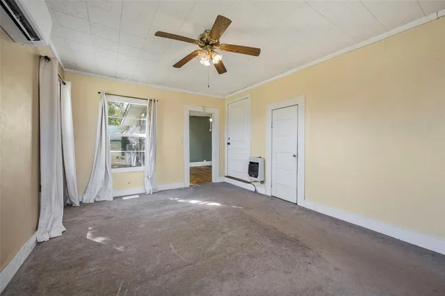 an empty room with closet and windows