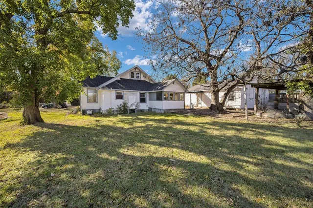 a front view of a house with swimming pool and porch