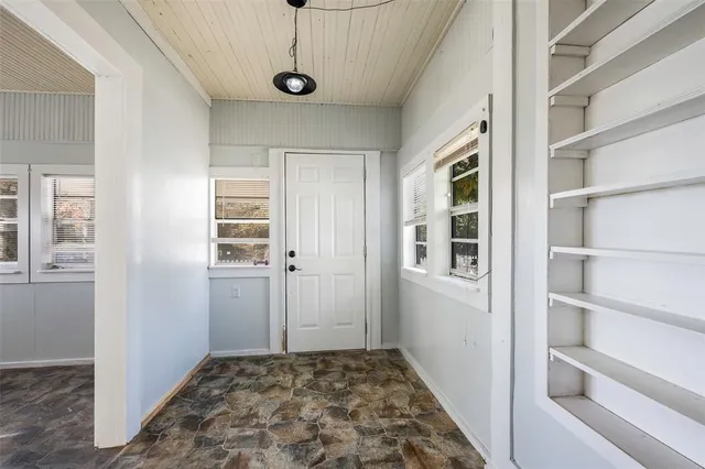 a view of a hallway with closet and window