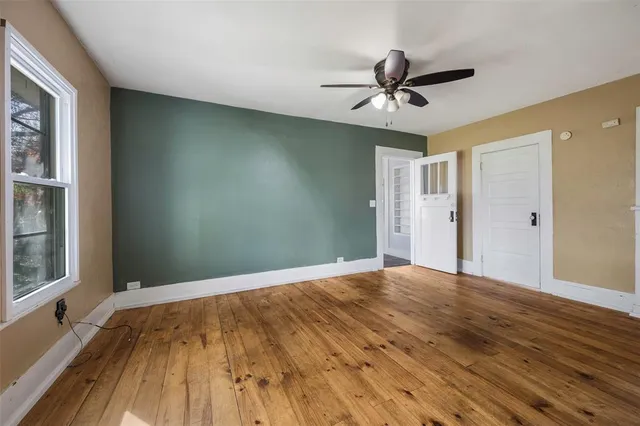 a view of a livingroom with a ceiling fan and window