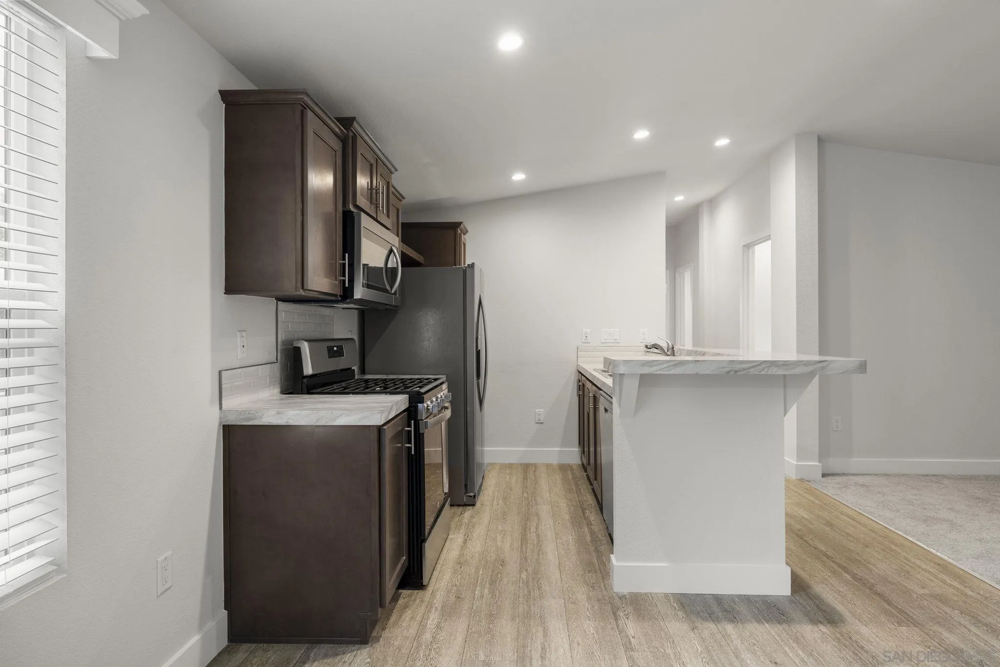 22899 Byron Road, Unit SPC 108 Crestline, CA 92325 - Photo 6 of 27 a kitchen with stainless steel appliances granite countertop a stove a sink and a refrigerator