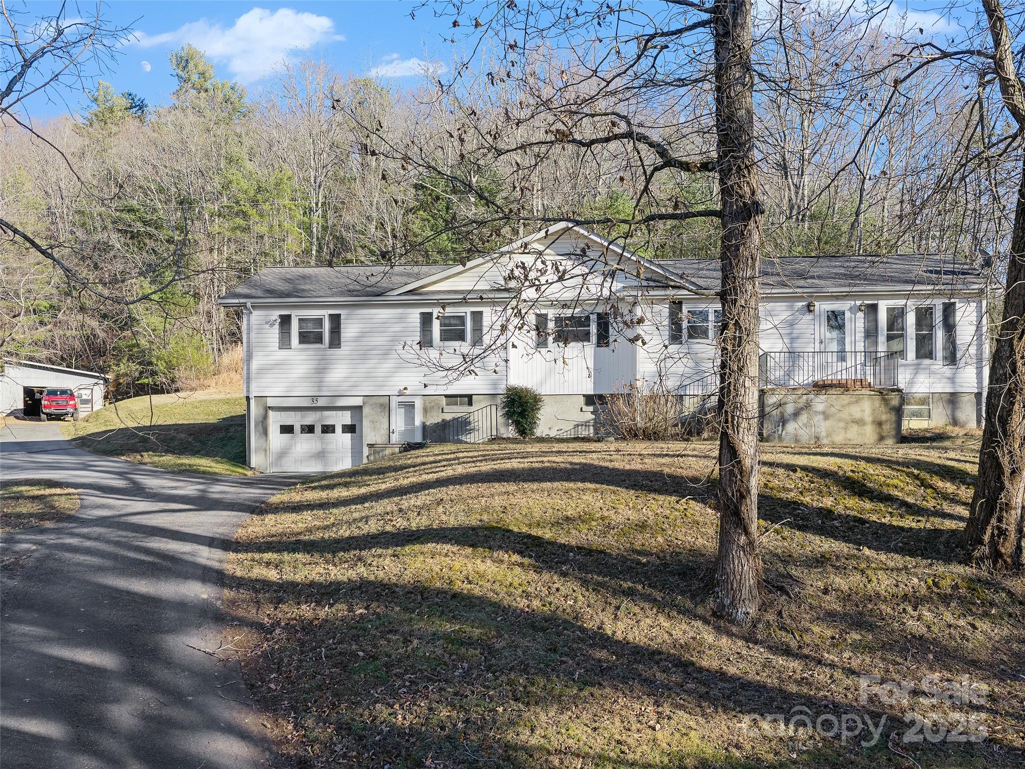 35 Smith Rdg Drive Asheville, NC 28803 - Photo 37 of 38 a view of a white house with a large tree and wooden fence