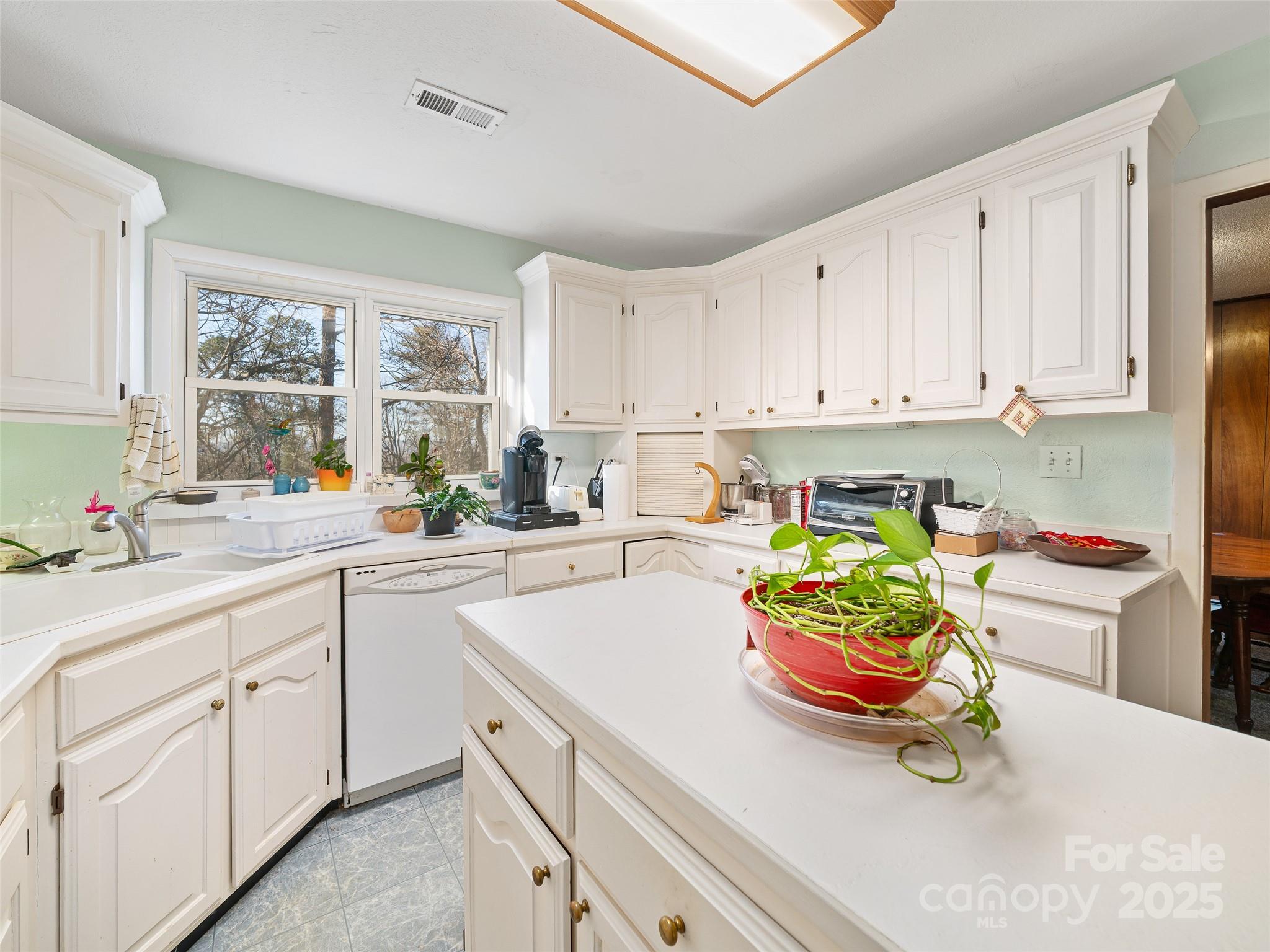 35 Smith Rdg Drive Asheville, NC 28803 - Photo 7 of 38 a kitchen with a sink a stove and white cabinets