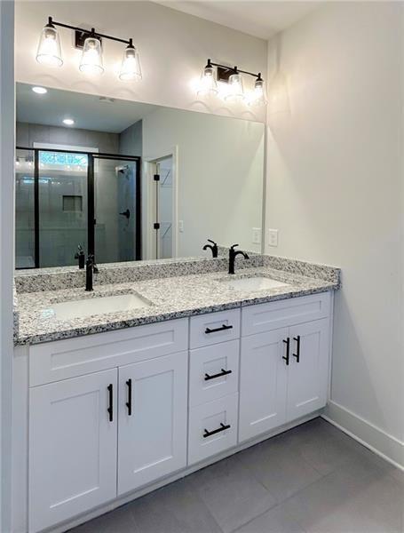 27 Bridgestone Way Cartersville, GA 30120 - Photo 28 of 31 a bathroom with a granite countertop double vanity sink and mirror