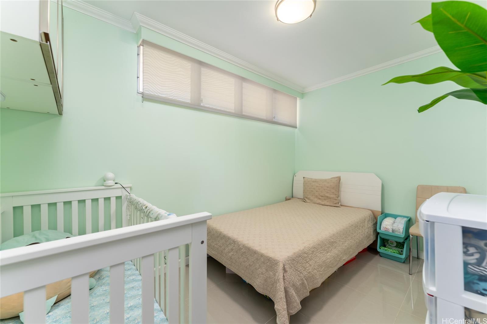 949 Ala Nanala Street, Unit 702 Honolulu, HI 96818 - Photo 12 of 23 a bedroom with a bed and a window